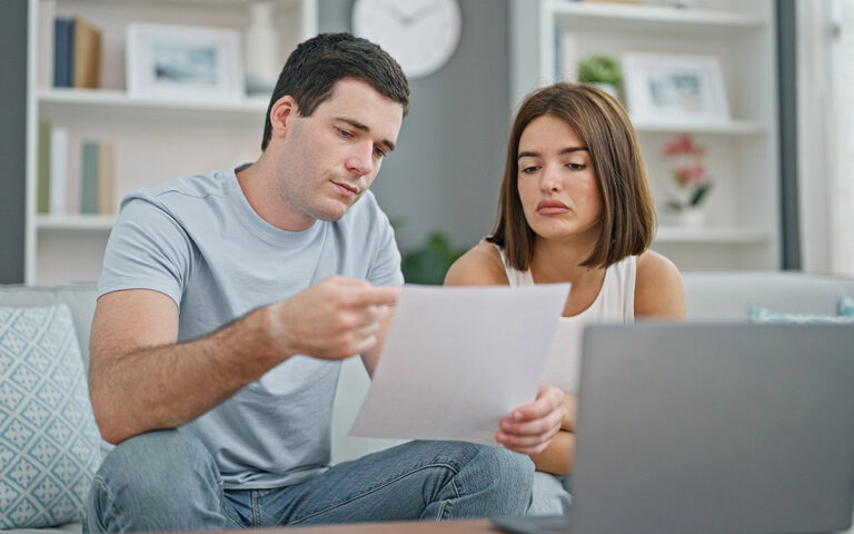 couple looking at documents budgeting