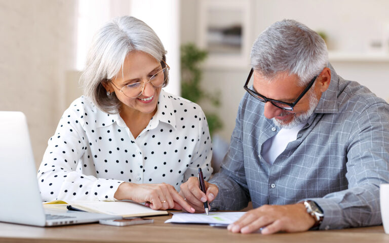 senior couple looking at tax documents
