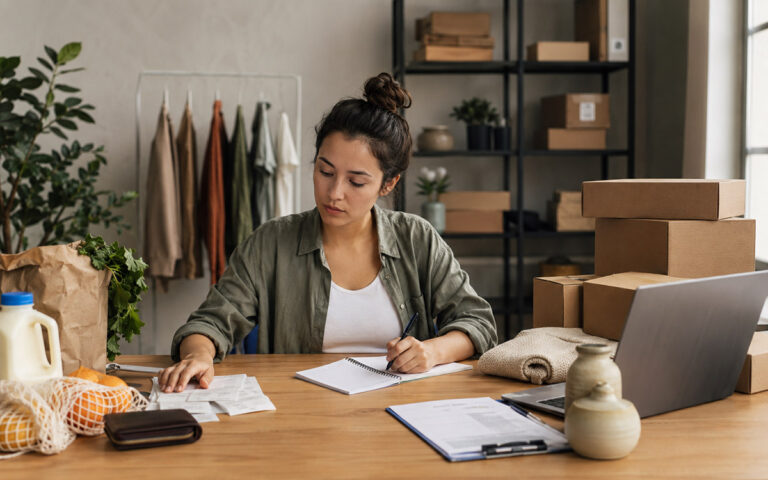 Separate Personal and Business Finances: A Guide entrepreneur working with documents and invoices