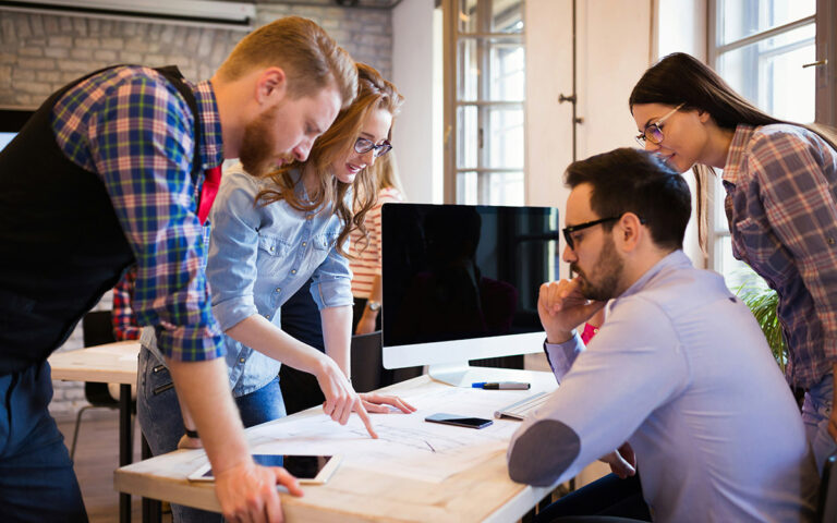 Sean Lovison Explains How to Evaluate Whether Entrepreneurship Fits Your Financial Independence Goals business team talking during meeting