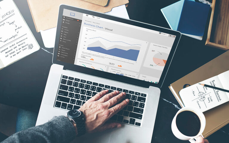Joel Freedman’s Mid-Year Financial Checkup: Insights from a Financial Advisor businessman working at the office in his laptop